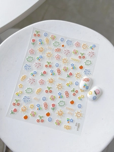 Detail of cute cartoon fruit and smile nail stickers with applied effect on white tips