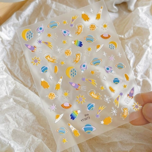 Space theme cartoon nail stickers with planets rockets and cats on white background