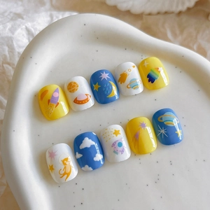Space-themed cartoon press-on nails featuring yellow and blue astronaut cat art