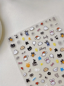 Close-up of cute cartoon nail stickers featuring rabbits, cats and rainbow patterns