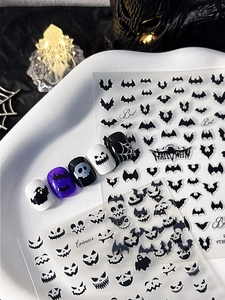 Detailed Halloween nail decals showing bat, pumpkin and skull designs on various colors