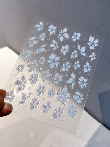 Detailed view of iridescent blue floral and butterfly self-adhesive nail art stickers