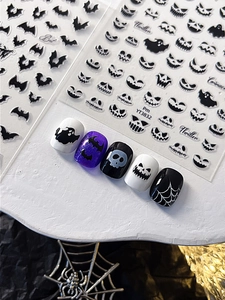 Detailed Halloween nail stickers featuring bats, ghosts, and skulls on sample tips