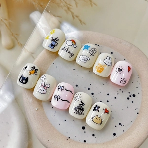 Cute cartoon press-on nails with rabbit, cat, and floral patterns in pink and cream