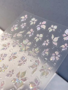 Macro view of 3D embossed laser nail stickers with iridescent floral jelly shell patterns