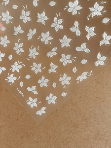 Detail of 3D embossed white cherry blossom nail stickers with clear adhesive backing