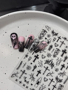 Detailed view of Gothic nail art stickers with cross and spider web patterns for Halloween