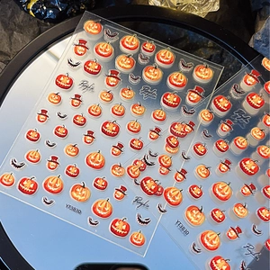 Halloween pumpkin lantern nail stickers with wizard hats and spooky faces on dark background