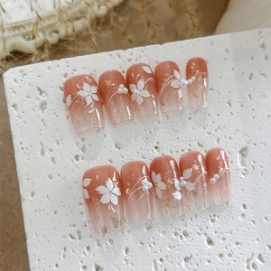 Pink gradient press-on nails with 3D white flowers, pearls and gold foil accents