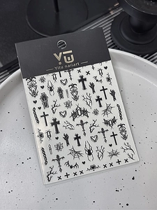 Macro shot of Gothic Halloween nail stickers with black bat and cross relief motifs