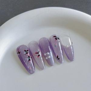 Faux ongles amande lilas avec motifs floraux peints à la main et perles fines