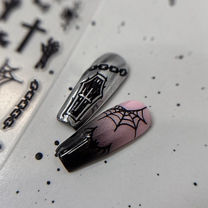 Gothic Halloween nail art stickers with silver crosses and black spider web patterns