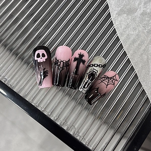 Gothic pink and black gradient press-on nails with skull and thorn designs