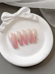 Pink gradient long trapezoid press-on nails with white floral patterns and rhinestones