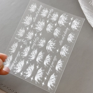 White flower and star nail art stickers with translucent texture on grey background