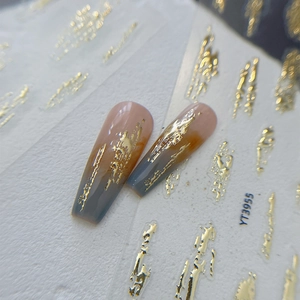Goldgeprägte Nailart-Sticker mit Marmortextur auf rosa und blauen Kunstnägeln
