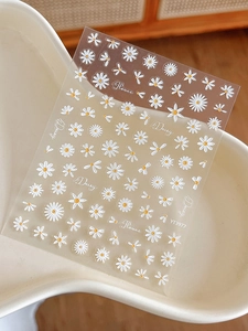 Detailed macro view of 3D embossed white daisy nail art stickers with flower text YT3977