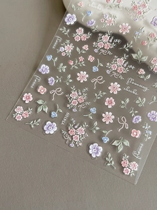 Detailed 3D embossed floral nail stickers with pink and blue flowers and bow ties