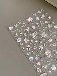 Detail of 3D embossed floral nail stickers featuring pink and purple flowers, model YT4109