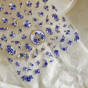 Blue and white porcelain style nail stickers with gold edges and floral patterns