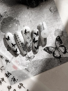 Detail of Chinese ink wash nail art stickers with butterfly and bamboo patterns