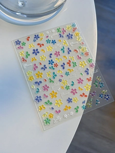 Close-up of colorful five-petal flower nail stickers with 3D jelly texture for manicure