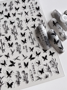 Detail of Chinese ink wash nail stickers with butterfly and bamboo motifs and calligraphy