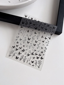 Macro detail of YT4166 nail stickers with black ink butterflies and bamboo leaf motifs