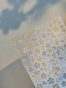 Macro detail of 3D embossed jelly floral nail stickers in pastel macaron colors