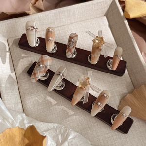 Handmade press-on nails with plaid patterns, 3D bows and pearl accents in warm autumn tones