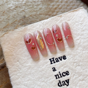 Pink gradient coffin nails with gold hearts, rhinestones, and foil flakes in 5 pieces