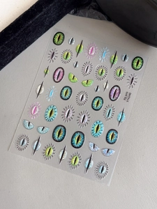 Macro detail of YT4240 evil eye nail stickers with sparkling textures and pupil patterns