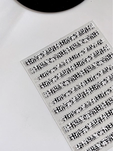 Close-up of vintage textured nail art sticker with elegant embossed relief pattern