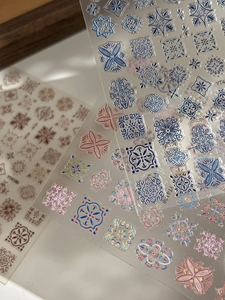 Detail shot of bohemian embossed nail stickers with intricate vintage tile patterns