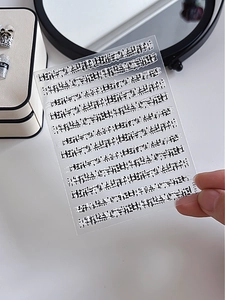 Detail view of monochrome typographic nail art stickers with relief texture, model YT4181