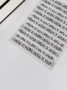 Macro shot of 3D embossed nail art stickers with black elegant patterns and YT4181 code