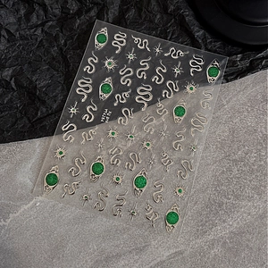 Emerald green snake nail stickers with golden eye accents and glitter stars decals