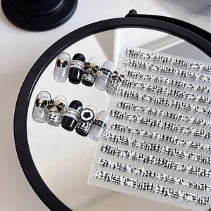 Chanel-style embossed nail art stickers with pearls, bows, and camellia 3D designs
