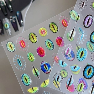3D cat eye nail stickers with colorful monster pupil designs and shimmering glitter texture