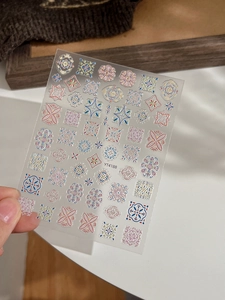 Close-up of bohemian embossed nail stickers featuring colorful mandala patterns and geometric shapes