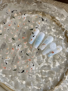 Detail of 3D embossed koi fish and lotus nail stickers with elegant Chinese calligraphy