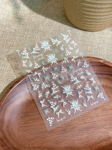 Macro detail of YT4111 5D embossed lily of the valley and butterfly nail art stickers