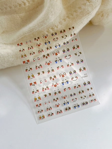 Close-up of cute cartoon facial expression nail art stickers with various emotions and icons