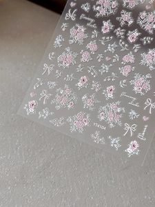 Detailed 3D embossed pink floral nail stickers with white bows and heart patterns