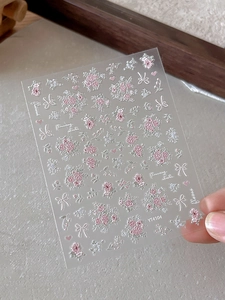 Macro view of YT4104 embossed floral nail stickers with pink flowers and bows