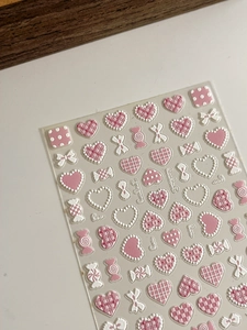 3D embossed nail stickers featuring pink heart and bow tie patterns with textured finish