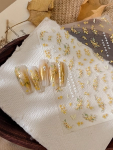 Detailed view of 3D embossed golden osmanthus nail stickers with pearl butterfly accents
