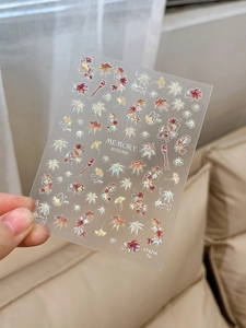 Detailed macro view of YT4214 iridescent maple leaf nail stickers with autumn motifs