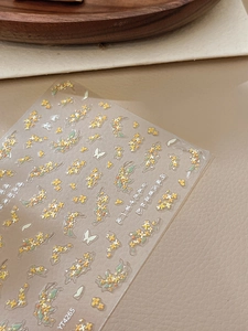 Close-up of golden osmanthus and butterfly 3D embossed nail stickers with art text