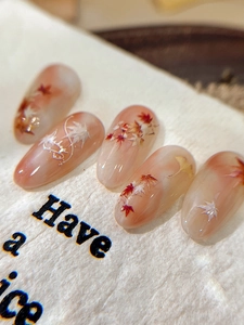 Detailed view of maple leaf nail stickers with autumn gradients and embossed 3D leaf designs